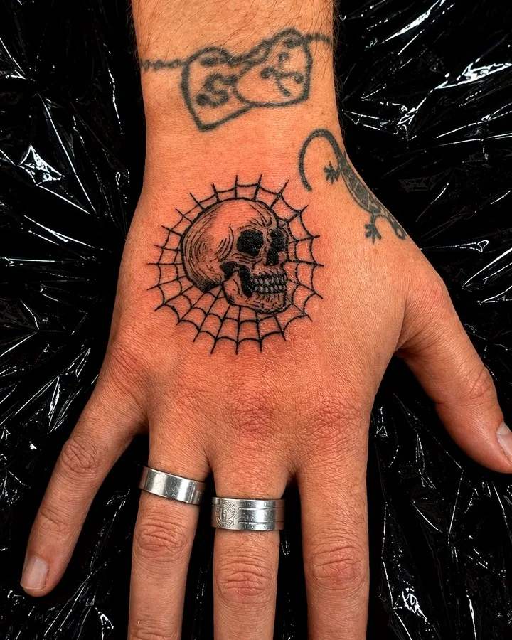 Skull hand tattoo detail by Tinta Libre Tattoo in Calella
